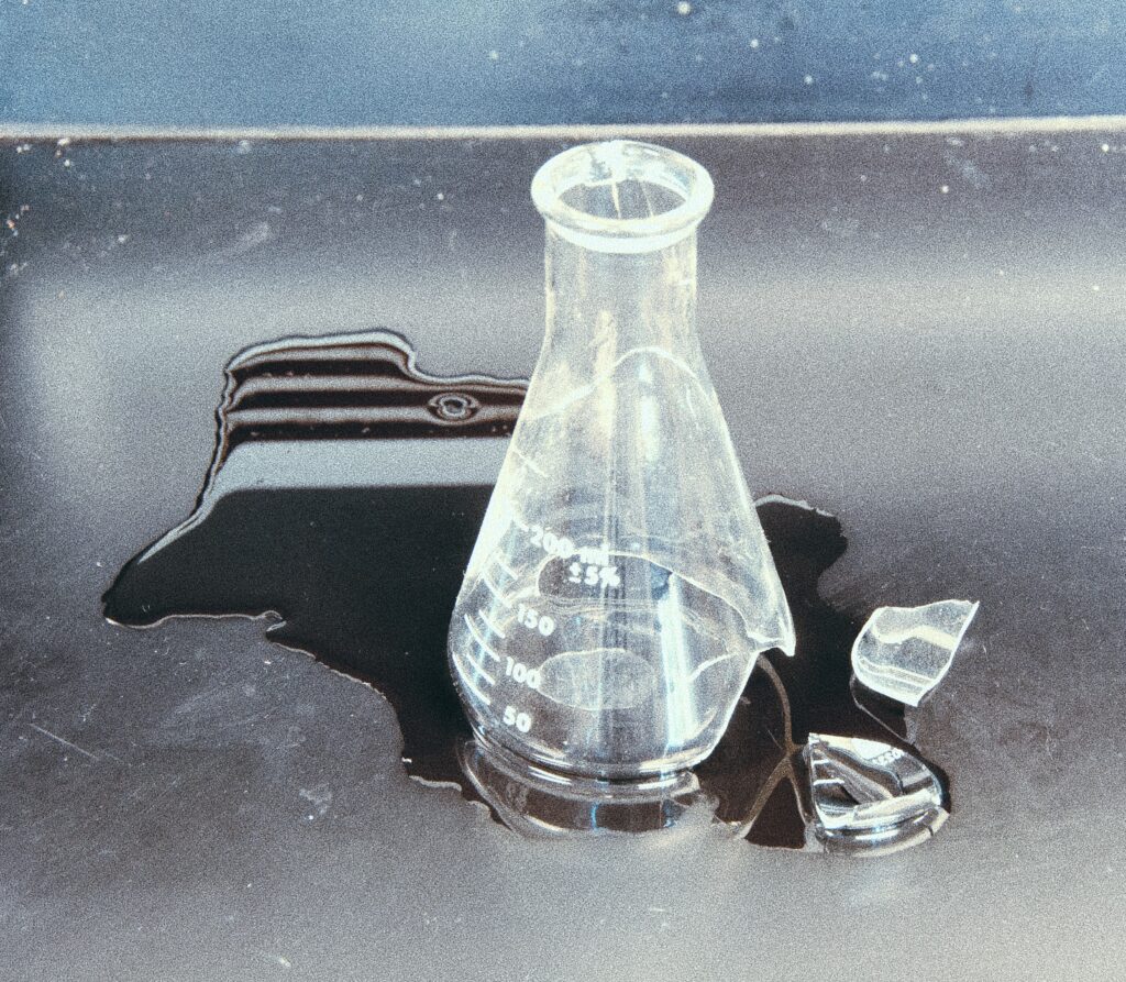 broken science beaker Broken flask on a lab bench