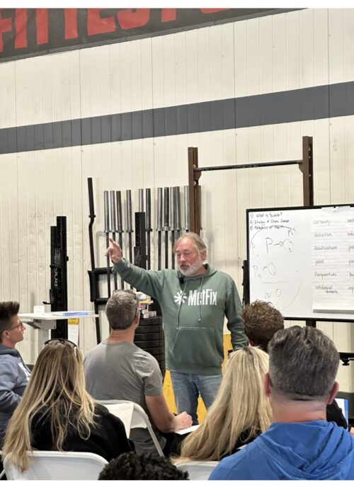 Greg at the MetFix whiteboard during a seminar